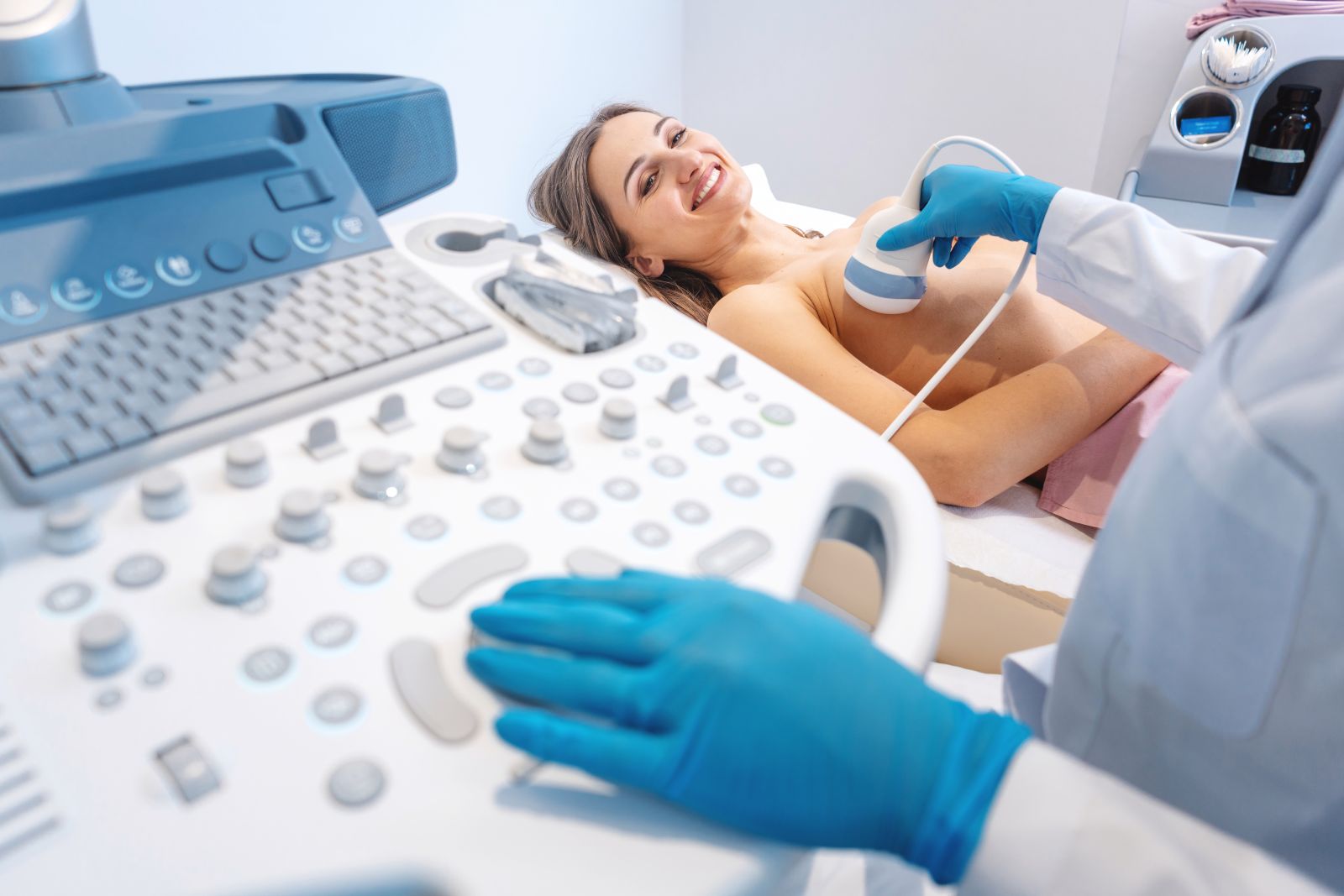 Woman patient having ultrasound scan on modern machine to prevent breast cancer